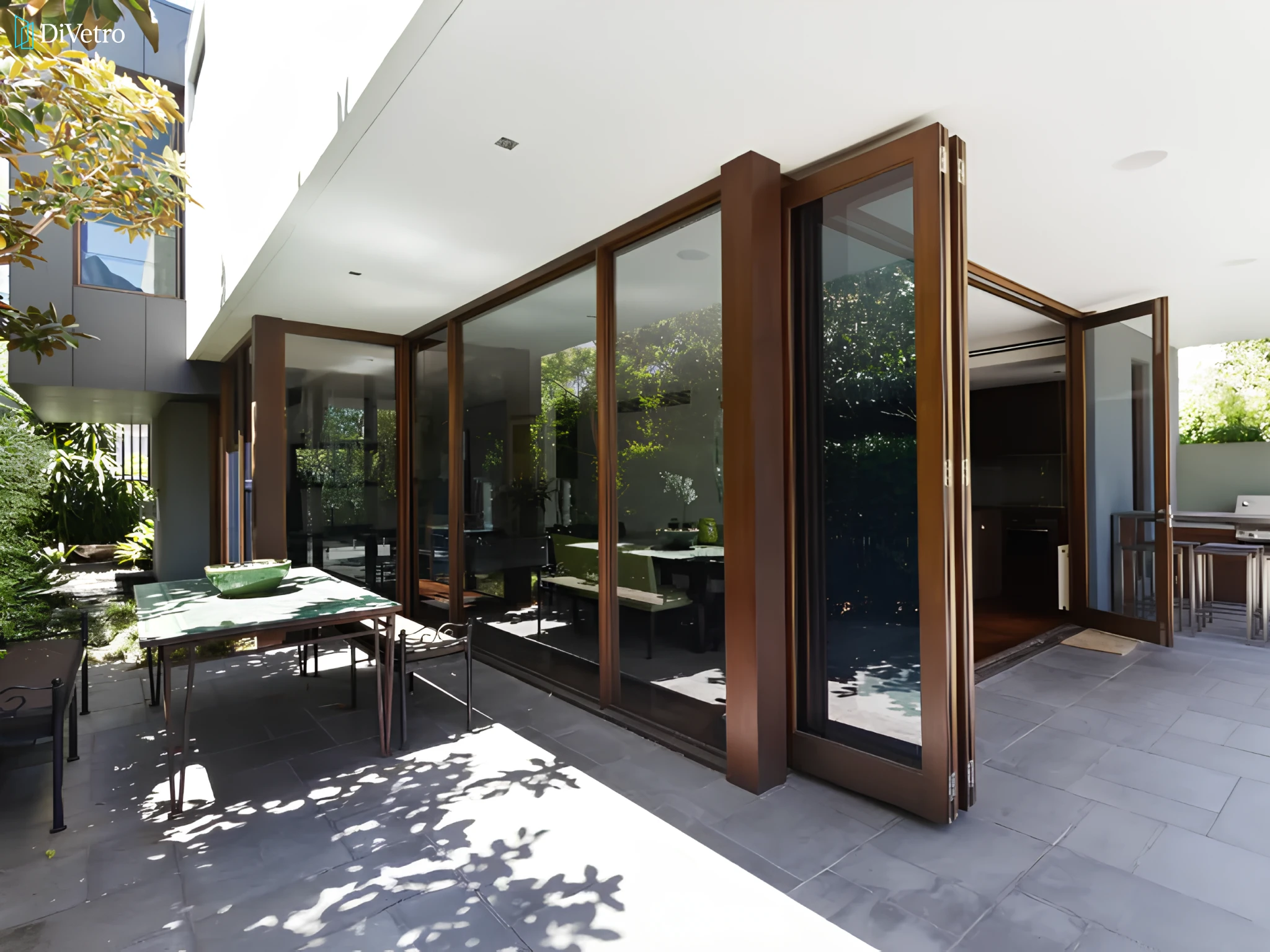 Bi-fold patio door with black aluminum frame on a contemporary home — real installation