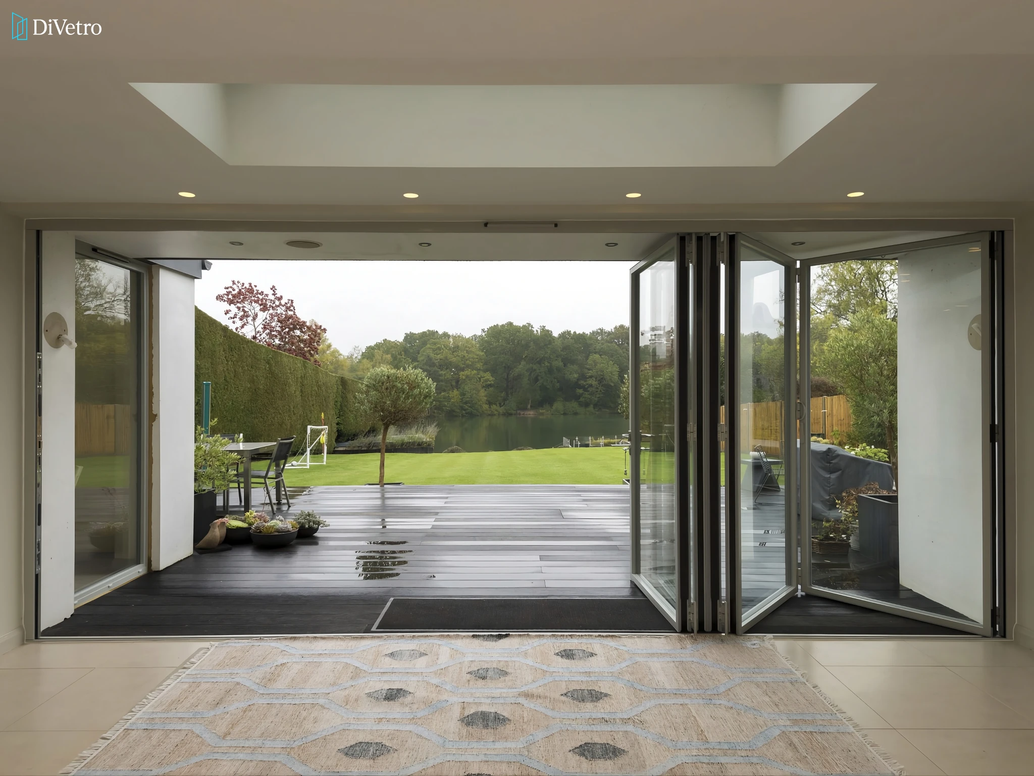 Bi-fold glass door with brushed stainless steel hardware on a luxury residence — real installation