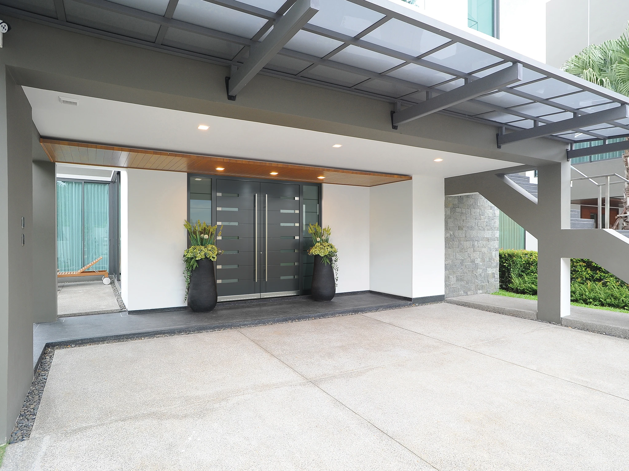 Front door with satinato glass panel and stainless steel hardware on a family home