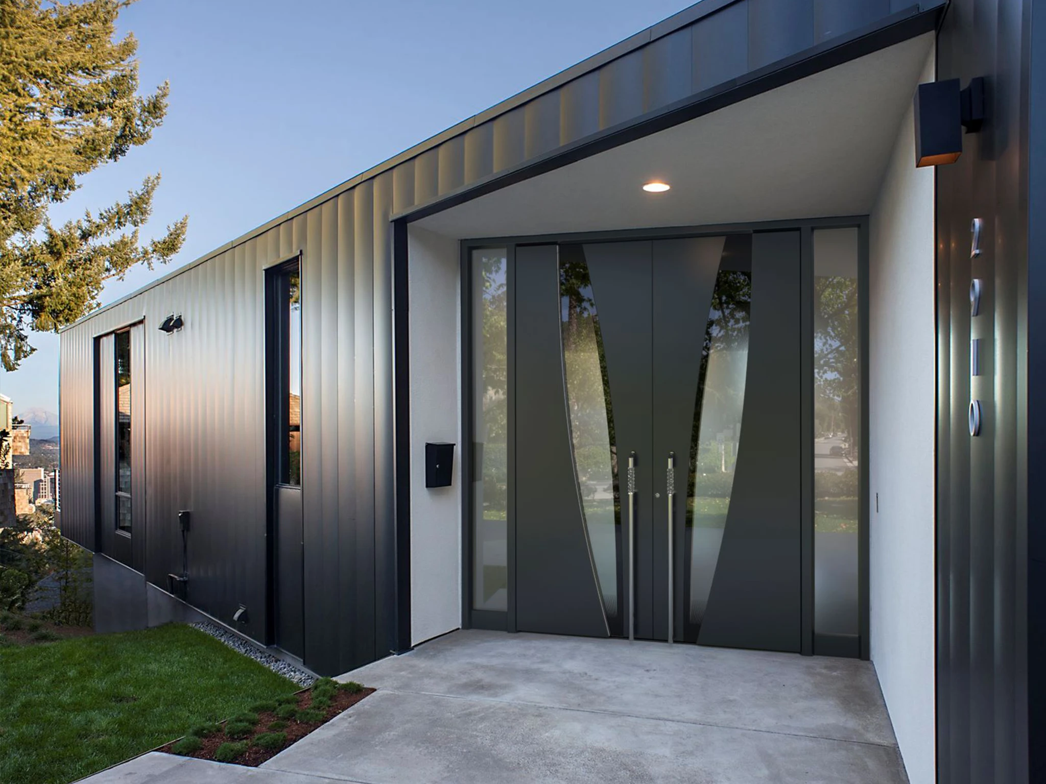 Premium entry door with motorized locking system on a modern house — real project