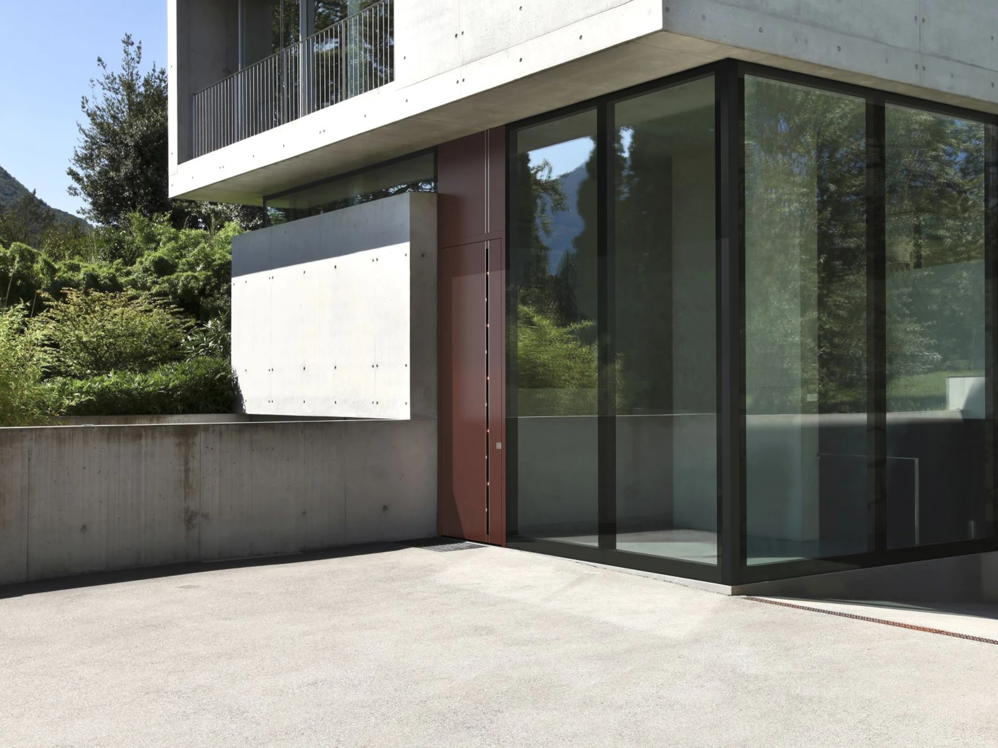 Modern front door with sidelight panels and concealed hinges on a family home