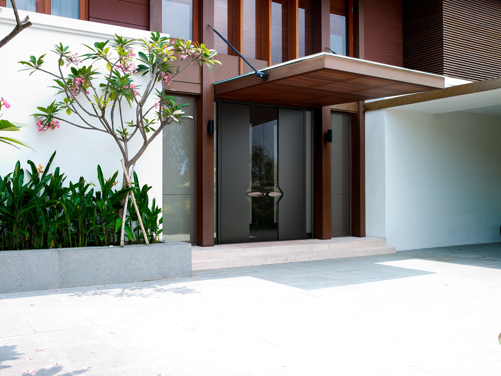 Entry door with PVD-finished hardware and ambient floor lighting — real project